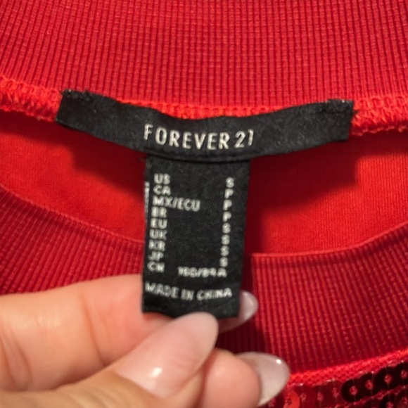 A knit tunic featuring allover sequin embellishments, front number "87" KC - Picture 6 of 6